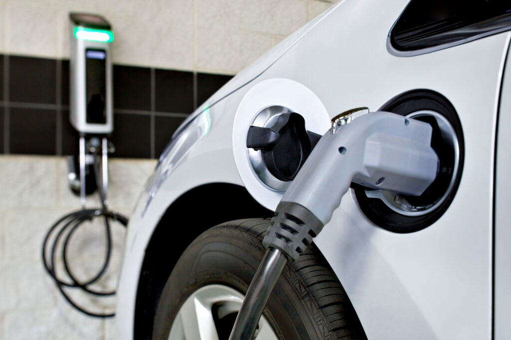 Electric automobile, plugged into charging station. (Greg Pease / Getty Images)