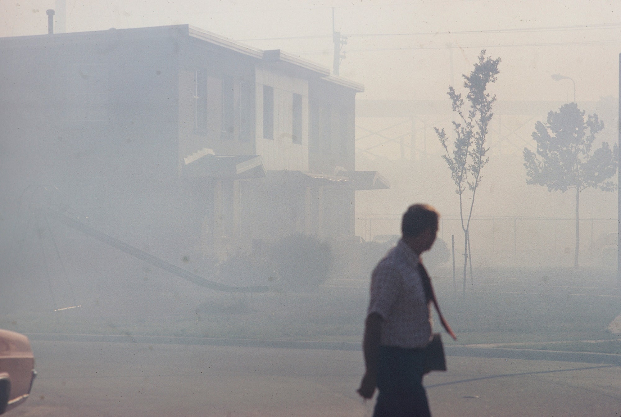 Industrial smog blacks out homes adjacent to the North Birmingham pipe plant in Birmingham, Alabama, July 1972.